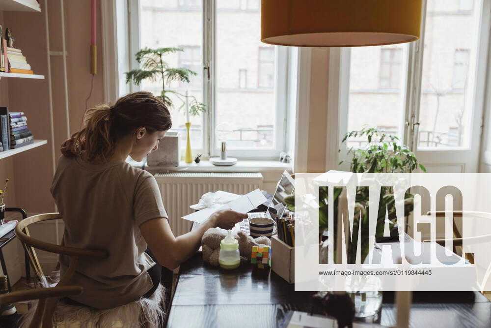 Rear view of female entrepreneur working at home office Sweden, Stockholm, model released, property released
