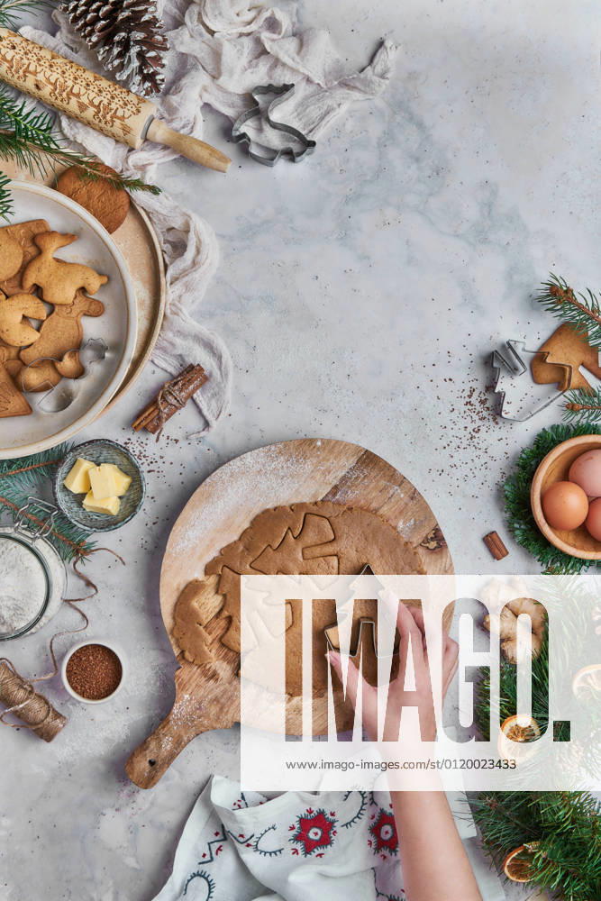 Top view of an anonymous woman preparing desserts for christmas at a table with christmas decorations