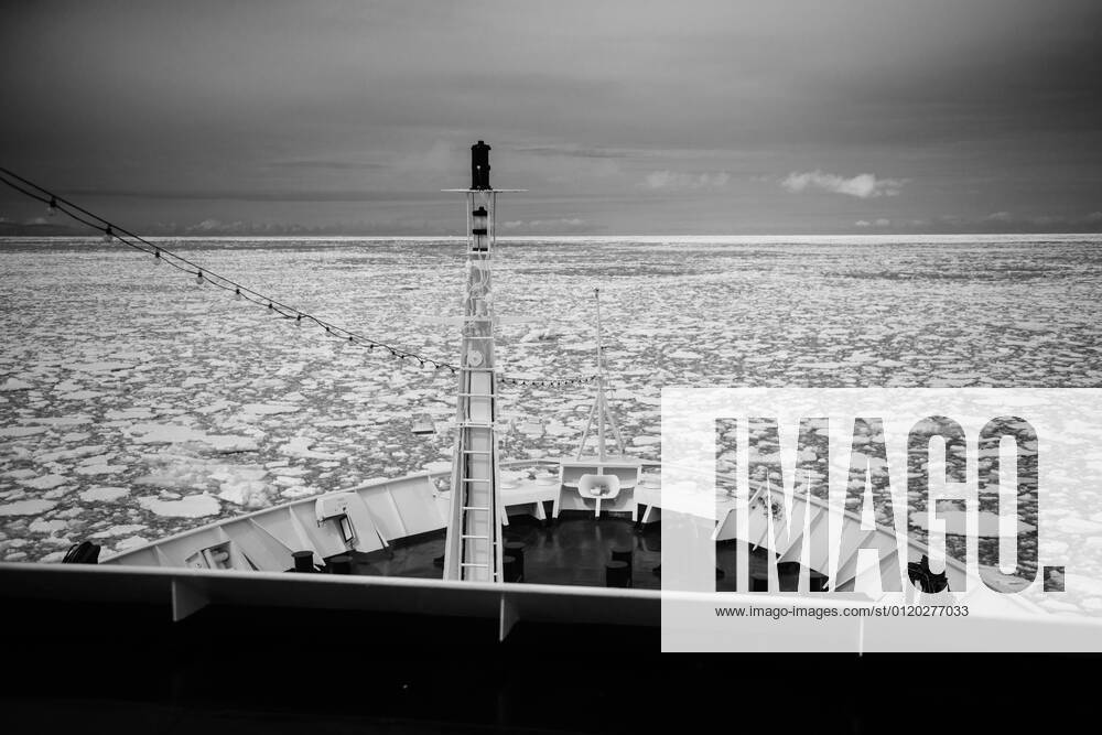 Cruise ship pushing through sea ice as it reaches the Antarctic Peninsula