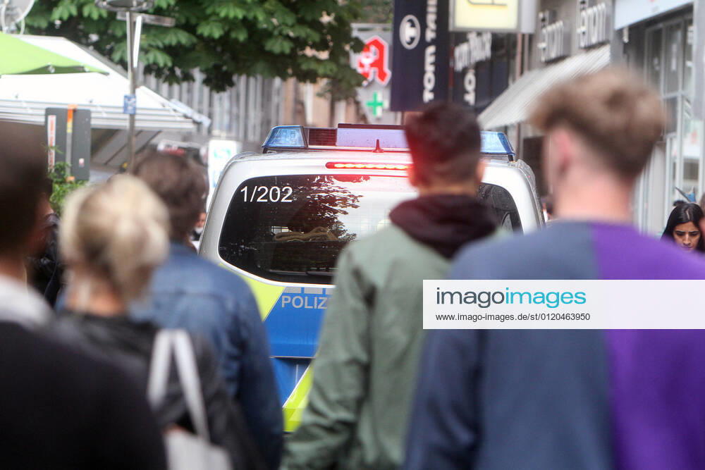 A police patrol of the state police Baden Württemberg controls the compliance with the minimum distances in the pedestrian zone and shopping street Königstraße in the city centre of Stuttgart, Baden Württemberg, Bavaria, Germany