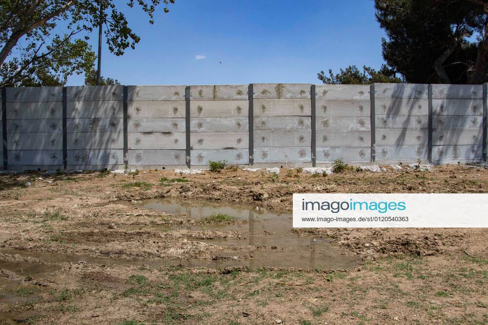 New Concrete Walls Around Diavata Refugee Camp In Greece Greece is building new concrete walls around the refugee camps across the country in the mainland and the islands. The 3meter wall was a decision by the Greek Ministry of Migration and European Commission. Asylum seekers feel like imprisonment conditions while the authorities claim its for their own security, monitoring the entrance and locking the camp during the night. Diavata refugee and migrant camp is a former military camp near the city of Thessaloniki in Northern Greece. The concrete fortification called enhanced fence has been built around the whole area of the camp. Diavata, Greece on June 6, 2021 Thessaloniki Greece economou-notitle210605_npDVN