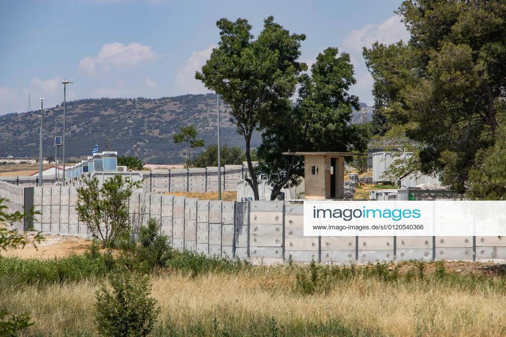 New Concrete Walls Around Diavata Refugee Camp In Greece Greece is building new concrete walls around the refugee camps across the country in the mainland and the islands. The 3meter wall was a decision by the Greek Ministry of Migration and European Commission. Asylum seekers feel like imprisonment conditions while the authorities claim its for their own security, monitoring the entrance and locking the camp during the night. Diavata refugee and migrant camp is a former military camp near the city of Thessaloniki in Northern Greece. The concrete fortification called enhanced fence has been built around the whole area of the camp. Diavata, Greece on June 6, 2021 Thessaloniki Greece economou-notitle210605_npmjh