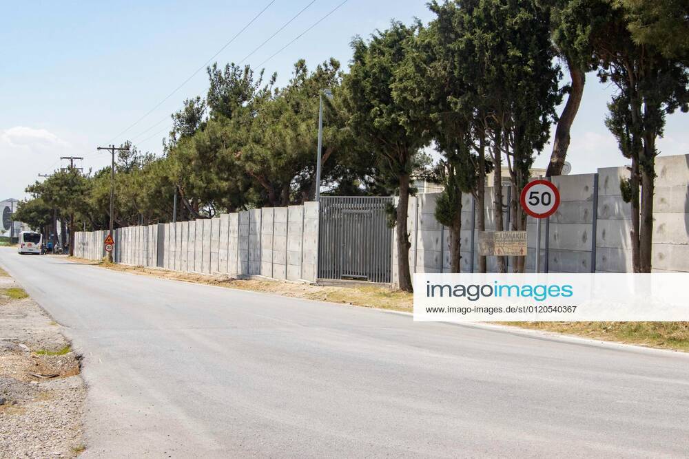 New Concrete Walls Around Diavata Refugee Camp In Greece Greece is building new concrete walls around the refugee camps across the country in the mainland and the islands. The 3meter wall was a decision by the Greek Ministry of Migration and European Commission. Asylum seekers feel like imprisonment conditions while the authorities claim its for their own security, monitoring the entrance and locking the camp during the night. Diavata refugee and migrant camp is a former military camp near the city of Thessaloniki in Northern Greece. The concrete fortification called enhanced fence has been built around the whole area of the camp. Diavata, Greece on June 6, 2021 Thessaloniki Greece economou-notitle210605_npmP6