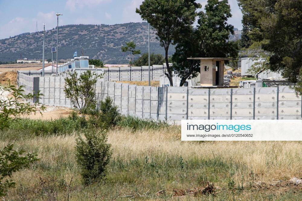 New Concrete Walls Around Diavata Refugee Camp In Greece Greece is building new concrete walls around the refugee camps across the country in the mainland and the islands. The 3meter wall was a decision by the Greek Ministry of Migration and European Commission. Asylum seekers feel like imprisonment conditions while the authorities claim its for their own security, monitoring the entrance and locking the camp during the night. Diavata refugee and migrant camp is a former military camp near the city of Thessaloniki in Northern Greece. The concrete fortification called enhanced fence has been built around the whole area of the camp. Diavata, Greece on June 6, 2021 Thessaloniki Greece economou-notitle210605_npiCr