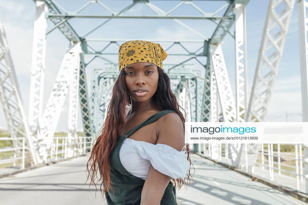 Woman with long hair at bridge during sunny day model released Symbolfoto JRVF00495