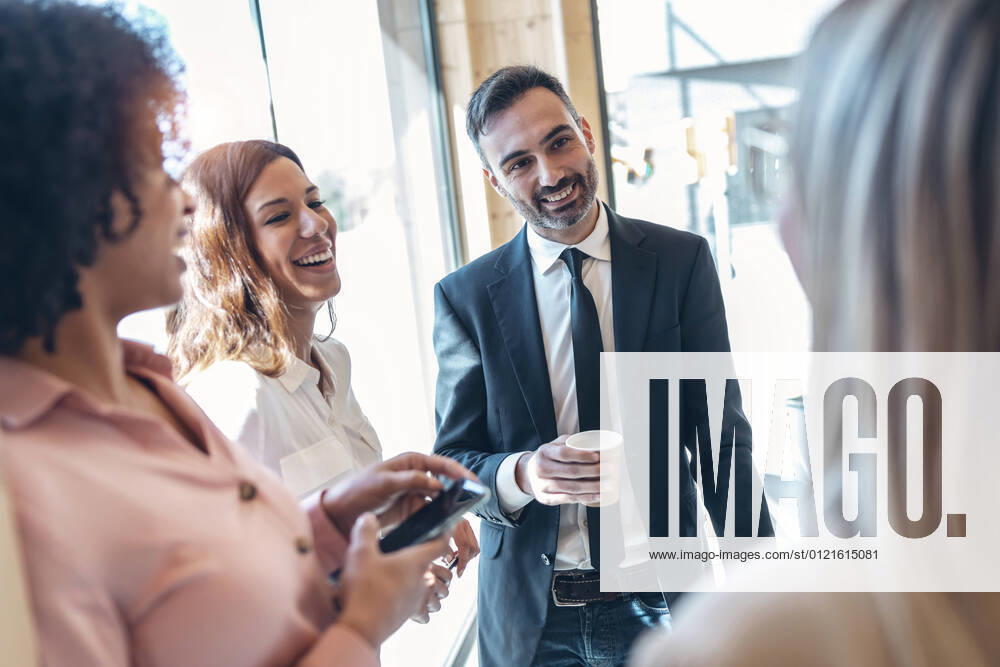 Smiling male professional with coworkers in office model released Symbolfoto property released JSRF01544