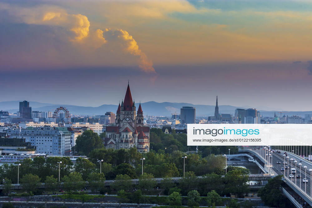 Vienna city center, river Donau (Danube), bridge Reichsbrücke, church Franz von Assisi, cathedral Stephansdom (St. Stephen s Cathedral), Ferris Wheel in Prater, cumulus storm cloud Wien, Vienna Wien Austria 00. overview