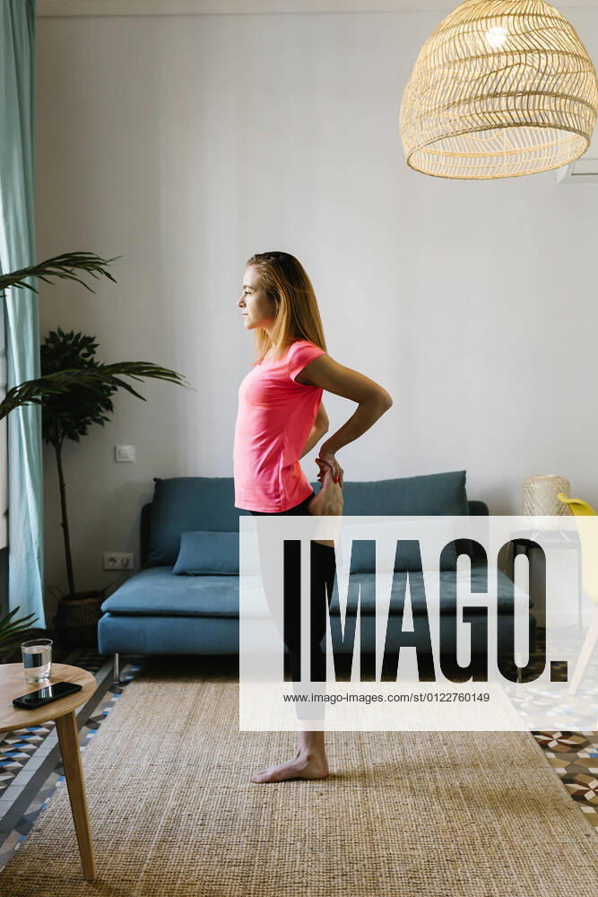 Young woman exercising at home model released Symbolfoto property released XLGF01907
