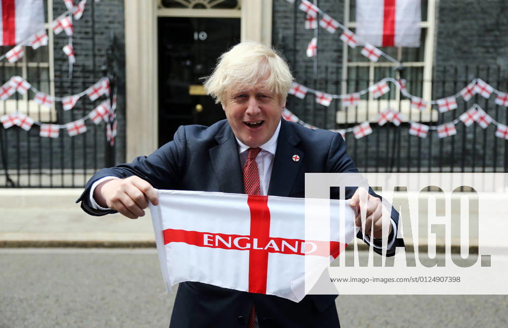 UK Prime Minister BORIS JOHNSON holds England flag outside 10 Downing Street ahead of Euro 2020 final match against Italy on Sunday. London United Kingdom - ZUMAs262 20210709_zip_s262_092