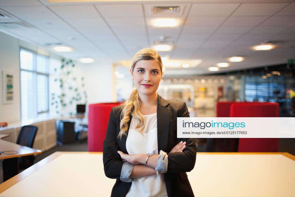 Portrait of young businesswoman standing in office.