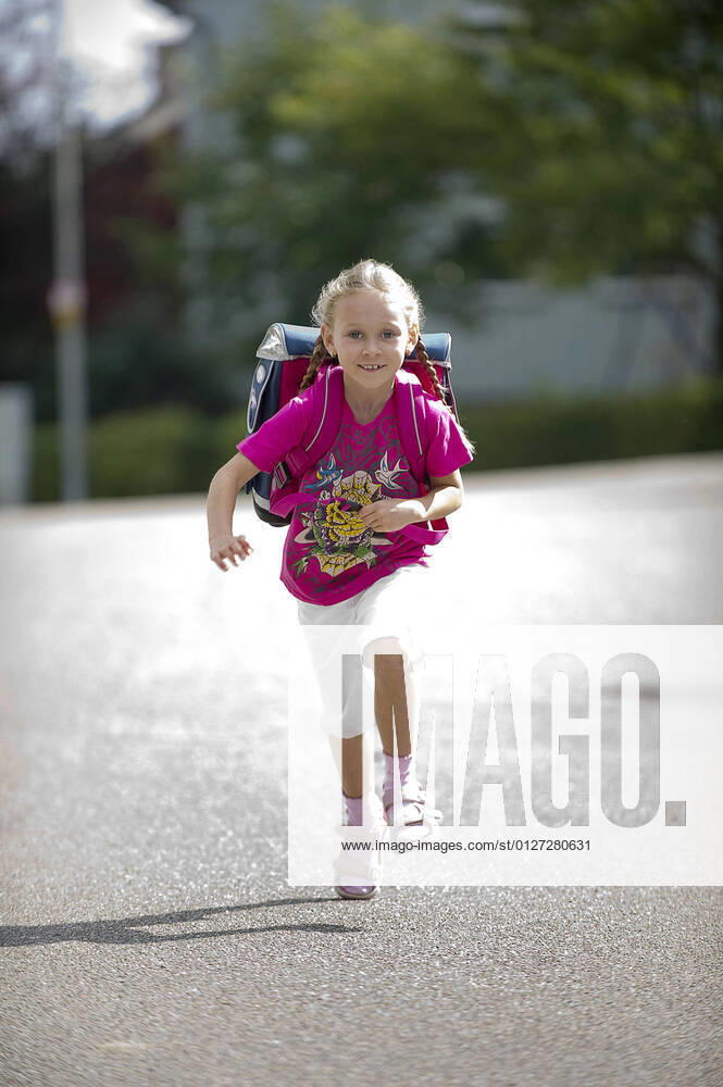 Happy schoolgirl at her first day of school , Germany BLWS648211