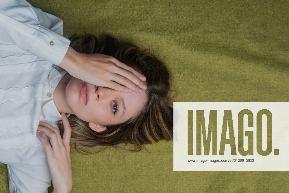 IMAGO Creative: Digitale Welt, Verzicht auf Technologie Top view of calm young long haired female with green eyes covering half of face with hand and looking at camera JoseDeJesusSaldana_GreenEyedWoman_24.jpg