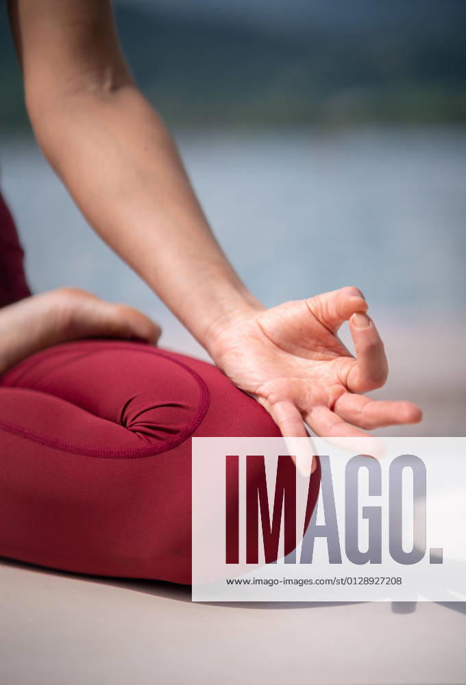 Serene female sitting in Padmasana on wooden pier and meditating while practicing yoga with mudra gestures near lake in summer TheTrioStudio_CharleneYogaLake_9.jpg