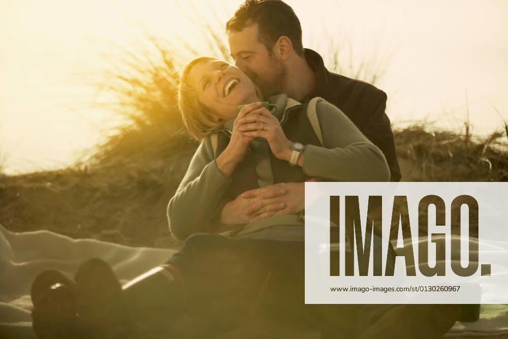 Couple on beach cuddling. With coffee RF, Marcus Lund, 25 03 2011,