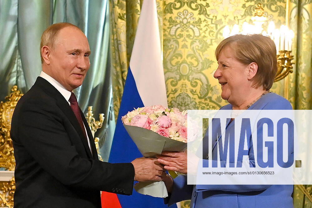 MOSCOW, RUSSIA â€“ AUGUST 20, 2021: Russiaâ€s President Vladimir Putin (L) presents flowers to Germanyâ€s Chancellor Angela Merkel during a meeting in the Moscow Kremlin. Merkel has announced that she will not stand for re-election in the upcoming German federal election, which is scheduled to be held in September 2021. Yevgeny Odinokov Russian Presidential Press and Information Office TASS TS10D18E