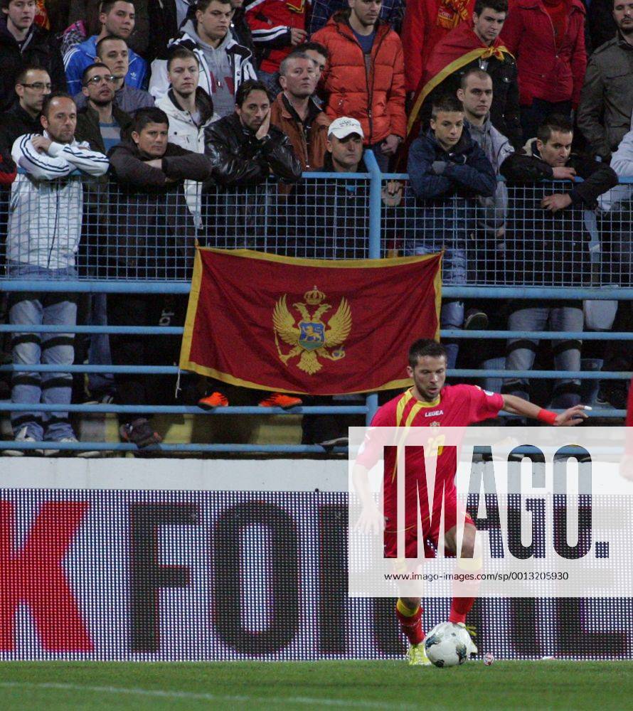 Podgorica(Montenegro) Montenegro-England FIFA world cup Brazil qualifiers men football Vladimir Bozovic(down) and Montenegro fans on the fence :