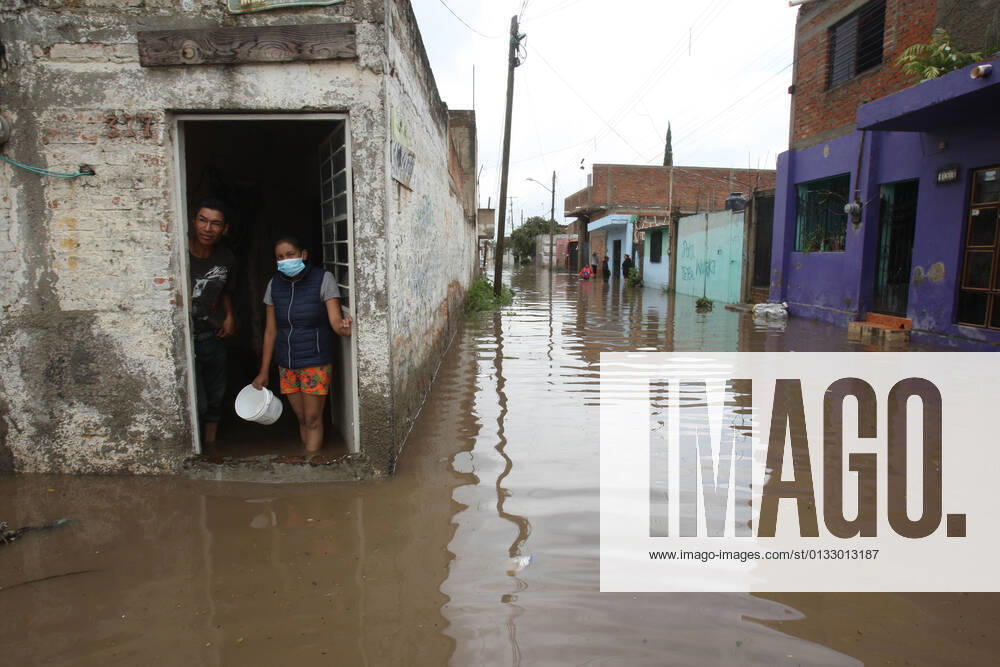 (210904) -- JALISCO, Sept. 4, 2021 -- People are seen inside a house flooded due to heavy rains, in the municipality of Tlaquepaque, State of Jalisco, Mexico, on Sept. 3, 2021. A strong storm during the early hours of Friday caused the El Chicharron and Las Pintas dams to overflow, flooding several areas of the municipality of Tlaquepaque. ) MEXICO-JALISCO-FLOOD ArturoxCampos