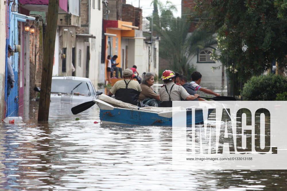 (210904) -- JALISCO, Sept. 4, 2021 -- People row a lifeboat on a street flooded due to heavy rains, in the municipality of Tlaquepaque, State of Jalisco, Mexico, on Sept. 3, 2021. A strong storm during the early hours of Friday caused the El Chicharron and Las Pintas dams to overflow, flooding several areas of the municipality of Tlaquepaque. ) MEXICO-JALISCO-FLOOD ArturoxCampos