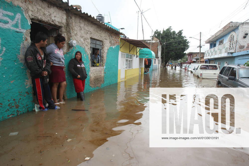 (210904) -- JALISCO, Sept. 4, 2021 -- People are seen on a street flooded due to heavy rains, in the municipality of Tlaquepaque, State of Jalisco, Mexico, on Sept. 3, 2021. A strong storm during the early hours of Friday caused the El Chicharron and Las Pintas dams to overflow, flooding several areas of the municipality of Tlaquepaque. ) MEXICO-JALISCO-FLOOD ArturoxCampos