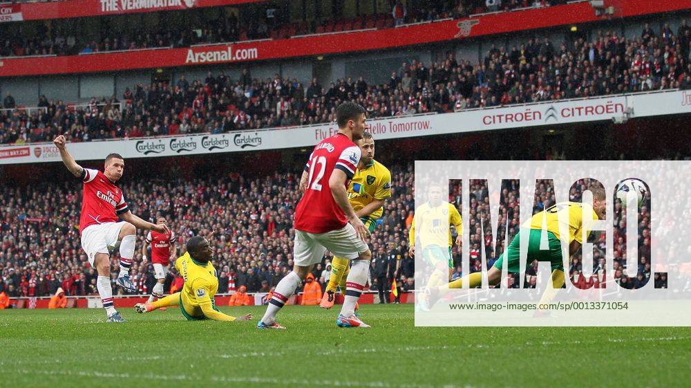 Arsenal s Lukas Podolski scoring his sides third goal.. FC Arsenal London vs Norwich City - Barclays Premier League - Emirates Stadium, London- 12 04 13 - .