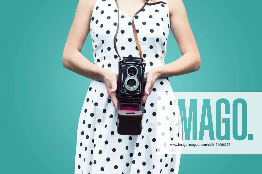 Close up of a woman in polka dress holding a camera, 26.10.2016 09:09:40,