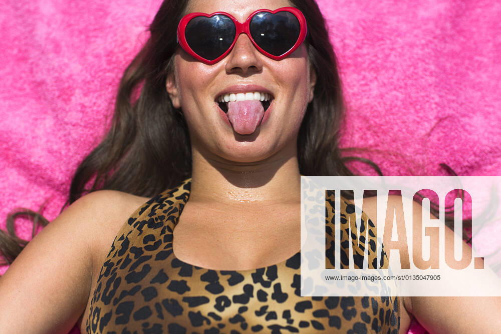 Portrait of young woman sunbathing pulling a face, 28.08.2014,