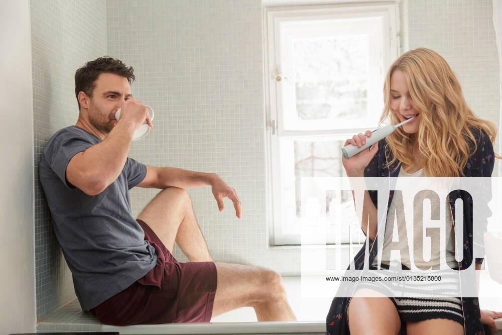 Couple in bathroom brushing teeth, 29.07.2016,