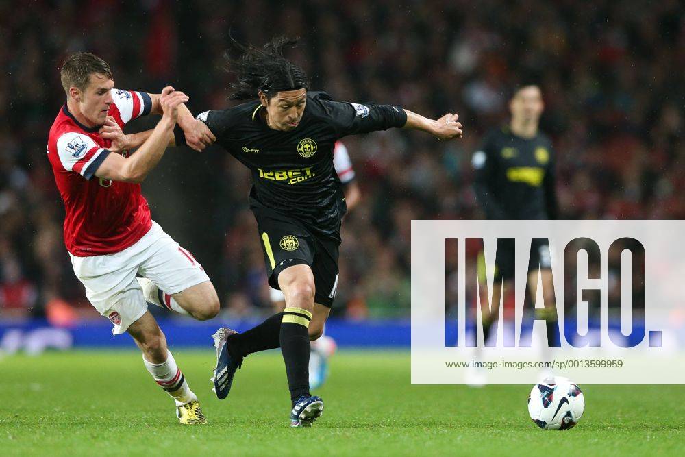 Football - 2012 2013 Premier League - Arsenal vs Wigan Wigan s Roger Espinoza and Aaron Ramsey of Arsenal at the Emirates Stadium, London