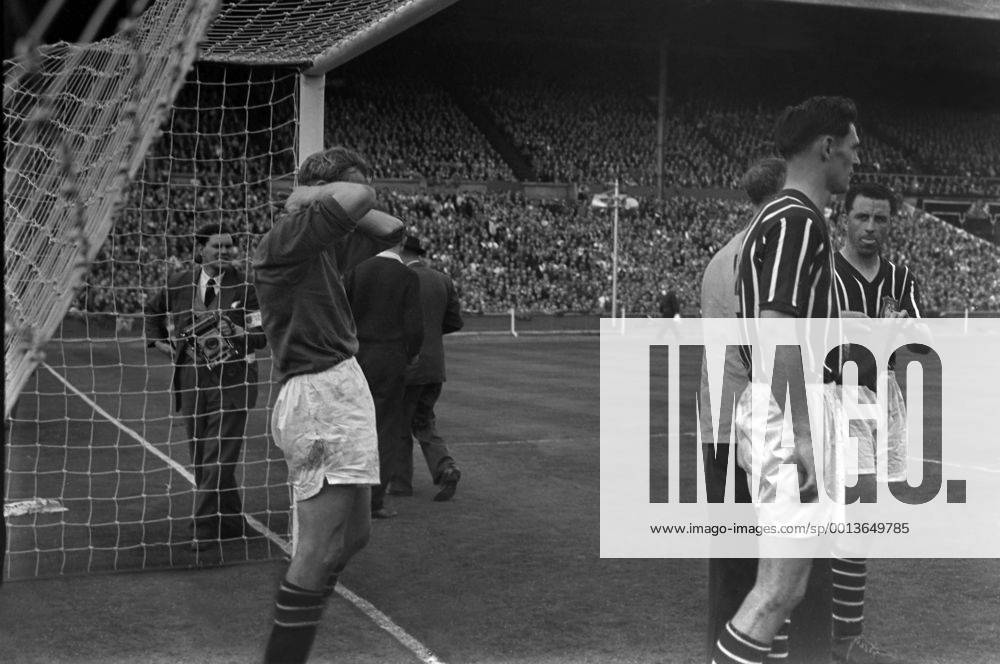 Football - 1956 FA Cup Final - Manchester City 3 Birmingham City 1 Bert Trautmann holds his neck in the goalmouth at Wembley. He had injured it after a collision with Peter Murphy. he remained on the field where he made some crucial late saves, however after the game it transpired he had broken his neck. 05 05 1956