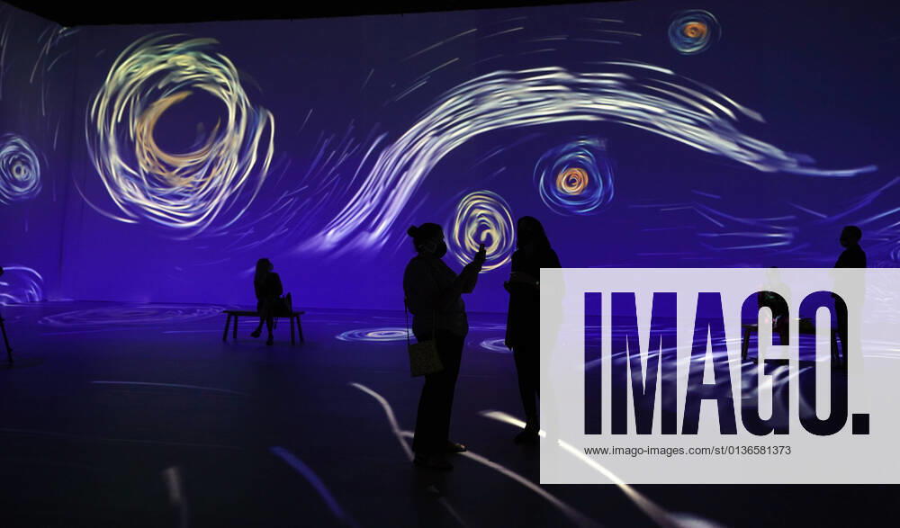 Visitors enjoy The Starry Night painting on preview day of Beyond Van Gogh: The Immersive Experience, in St. Louis on Thursday, September 30, 2021. Beyond Van Gogh uses projection technology to create a journey into the world of Van Gogh. SLP2021093003 BILLxGREENBLATT