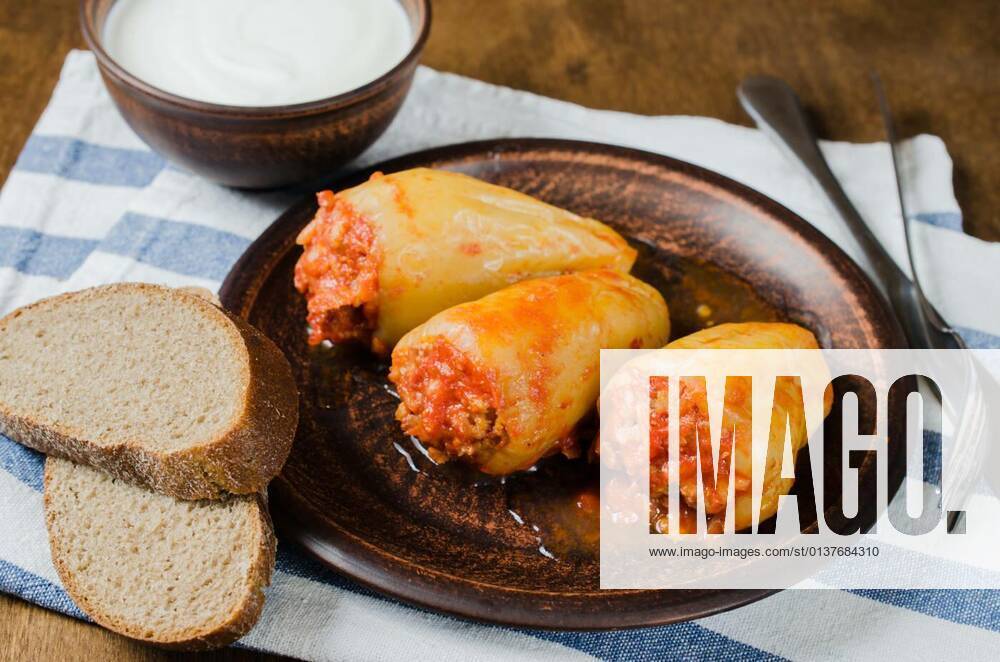 Stuffed peppers with rice and minced meat stew in tomatoes, rye bread. Rustic food., 13.10.2020,