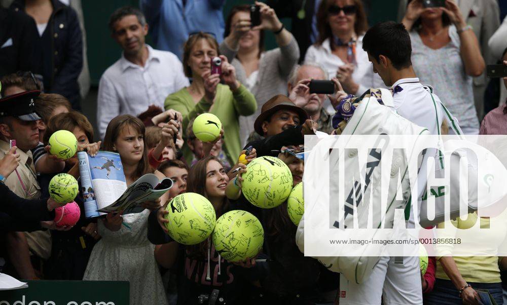 Novak Djokovic of Serbia signs for fans after the first round of men s singles on day 2 of the Wimbledon Lawn Tennis Championships at the All England Lawn Tennis and Croquet Club in London, Britain, on June 25, 2013.
