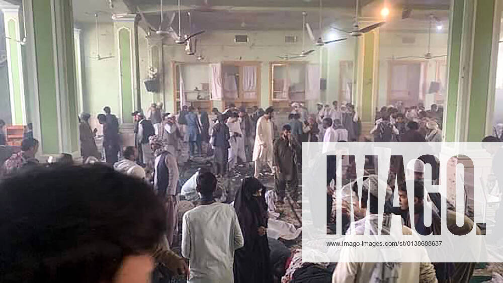 Afghan men inspect the damage and victims inside a Shiite mosque after a suicide bomb blasts during Friday congregational prayers at Shi ite Muslims Mosque in Kandahar, Afghanistan, on Friday, October 15, 2021. At least 40 people were killed and dozens others injured in the blast during the Friday noon prayer that is usually attended by about 500, witnesses said. AFG2021101504 Razmal