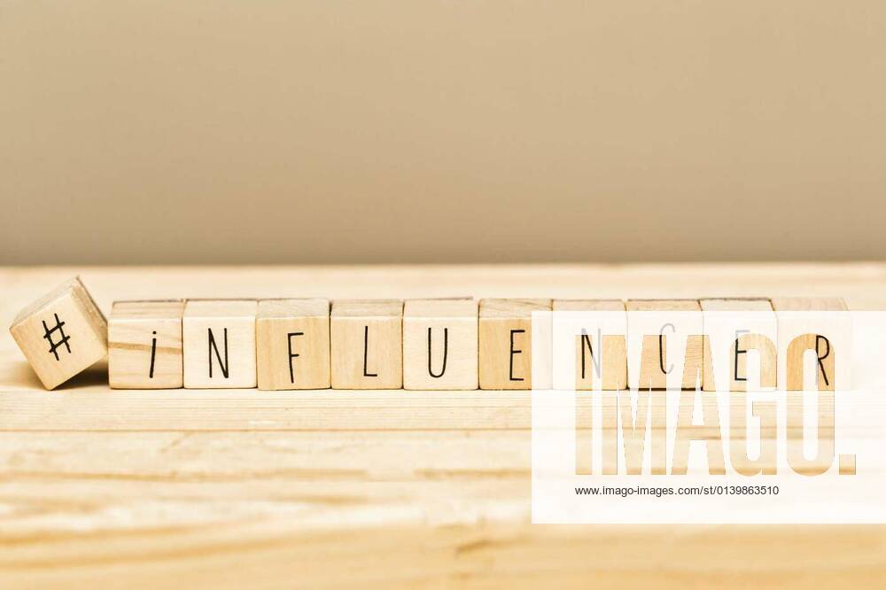 Wooden cubes with a hashtag and the word Influencer, social media concept and background, 14.10.2020,