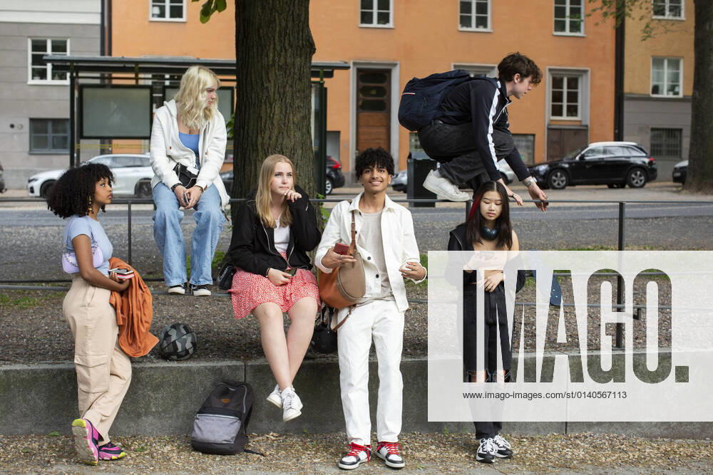 Male and female friends spending leisure time on footpath Sweden, Stockholm, model released