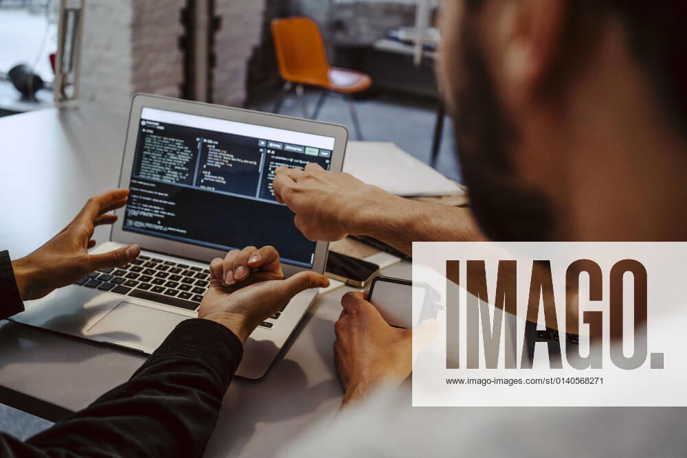 Male hackers doing coding over laptop at startup company Germany, Berlin, model released, property released