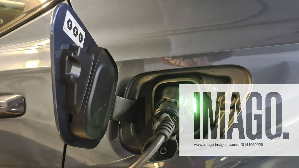 Electric car is charged in an underground car park Electric car is charged in an underground car park BLWS655089