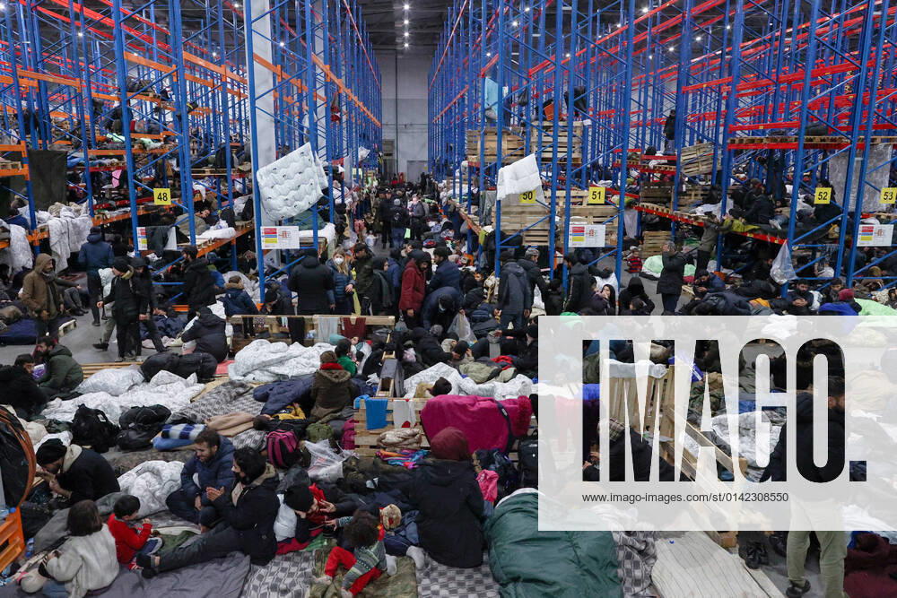 KW46 GRODNO REGION, BELARUS - NOVEMBER 19, 2021: Refugees at the Bruzgi Transport Logistical Centre, some 1.5 km northeast of Kuznica Bialostocka-Bruzgi border crossing on the Belarusian-Polish border. The migrant crisis on the border of Belarus with Poland, Lithuania, and Latvia escalated on November 8. This year, Polish border guards have prevented more than 35,000 attempts to illegally cross the Polish-Belarusian border, which is 400 times more than last year. Sergei Bobylev TASS TS1188E4