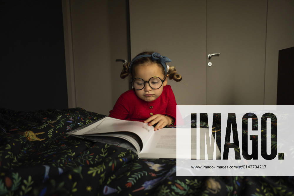 Cute girl reading book in bedroom model released property released, SSGF00215