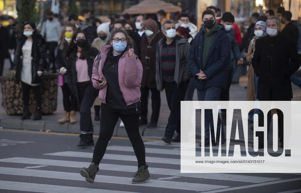 People wearing face masks walk on a street in Ankara, Turkey, on November 28, 2021. Turkey confirmed 21,655 new COVID-19 cases, raising its tally of infections to 8,746,055 according to its health ministry. Some 213 persons died of Covid-9 today, increasing the death toll from the virus in Turkey to 76,446. (