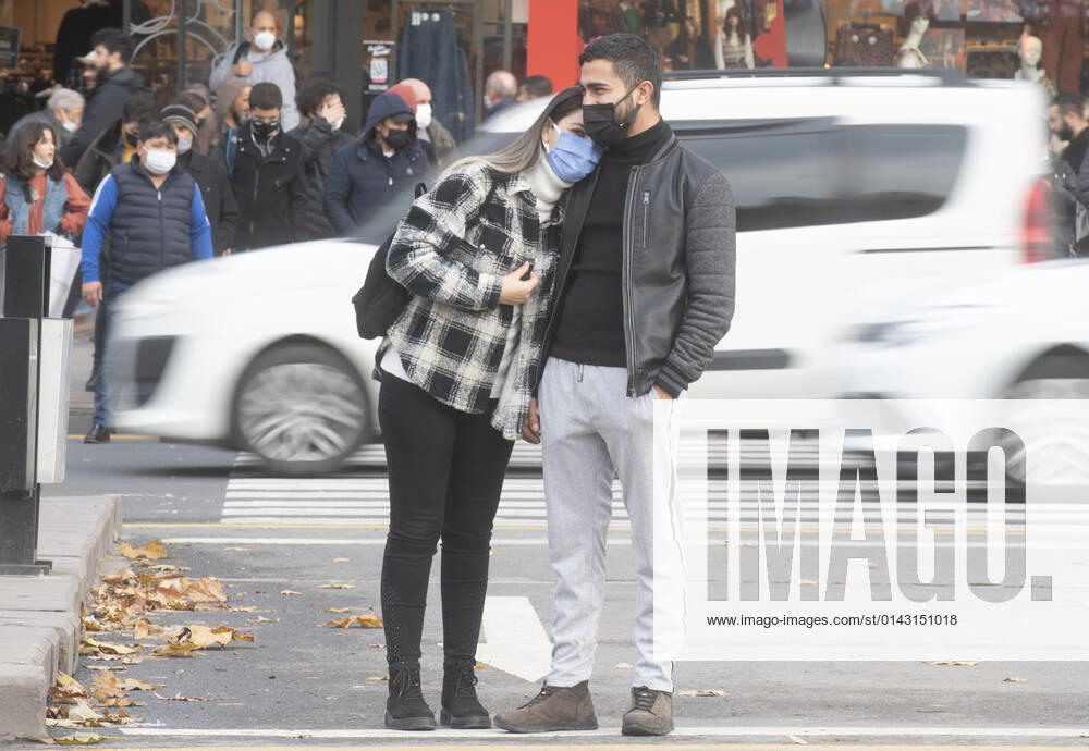 People wearing face masks walk on a street in Ankara, Turkey, on November 28, 2021. Turkey confirmed 21,655 new COVID-19 cases, raising its tally of infections to 8,746,055 according to its health ministry. Some 213 persons died of Covid-9 today, increasing the death toll from the virus in Turkey to 76,446. (