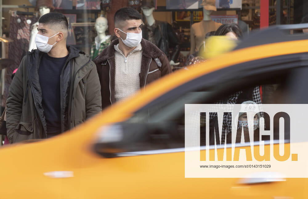 People wearing face masks walk on a street in Ankara, Turkey, on November 28, 2021. Turkey confirmed 21,655 new COVID-19 cases, raising its tally of infections to 8,746,055 according to its health ministry. Some 213 persons died of Covid-9 today, increasing the death toll from the virus in Turkey to 76,446. (