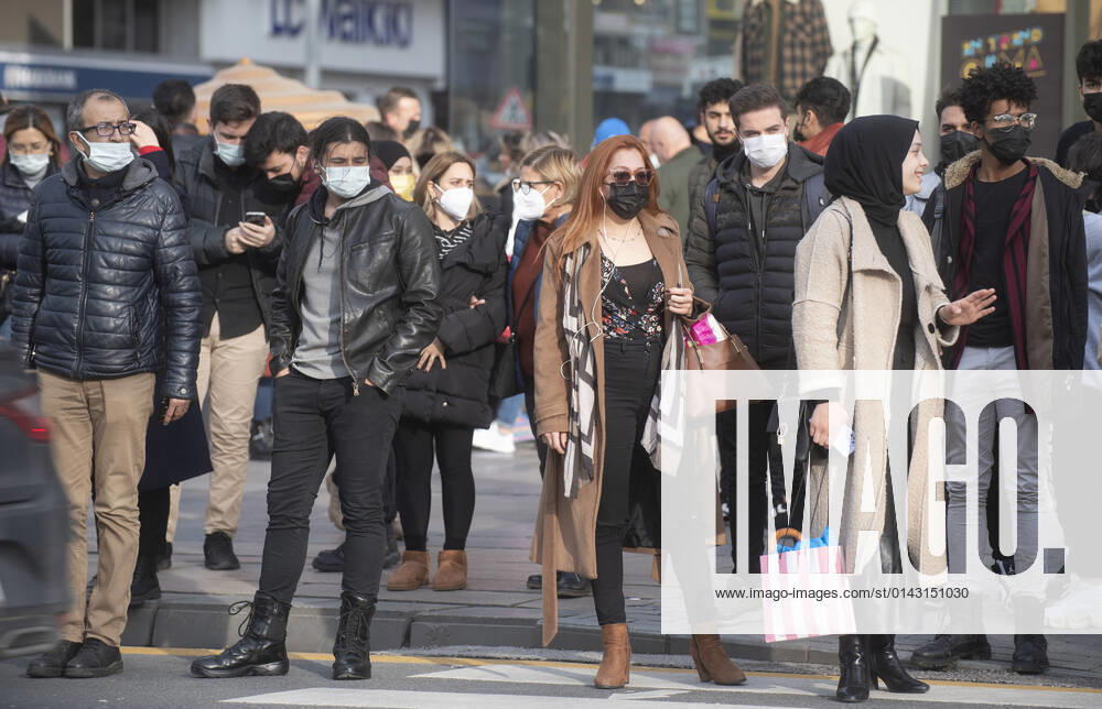 People wearing face masks walk on a street in Ankara, Turkey, on November 28, 2021. Turkey confirmed 21,655 new COVID-19 cases, raising its tally of infections to 8,746,055 according to its health ministry. Some 213 persons died of Covid-9 today, increasing the death toll from the virus in Turkey to 76,446. (