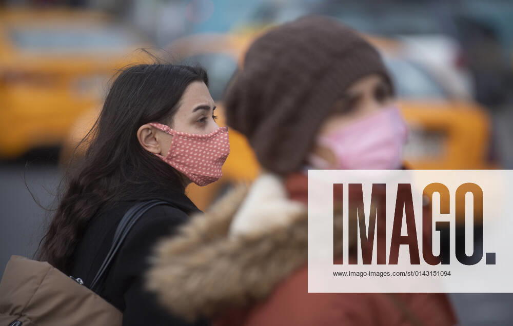 People wearing face masks walk on a street in Ankara, Turkey, on November 28, 2021. Turkey confirmed 21,655 new COVID-19 cases, raising its tally of infections to 8,746,055 according to its health ministry. Some 213 persons died of Covid-9 today, increasing the death toll from the virus in Turkey to 76,446. (