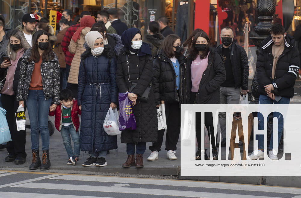 People wearing face masks walk on a street in Ankara, Turkey, on November 28, 2021. Turkey confirmed 21,655 new COVID-19 cases, raising its tally of infections to 8,746,055 according to its health ministry. Some 213 persons died of Covid-9 today, increasing the death toll from the virus in Turkey to 76,446. (