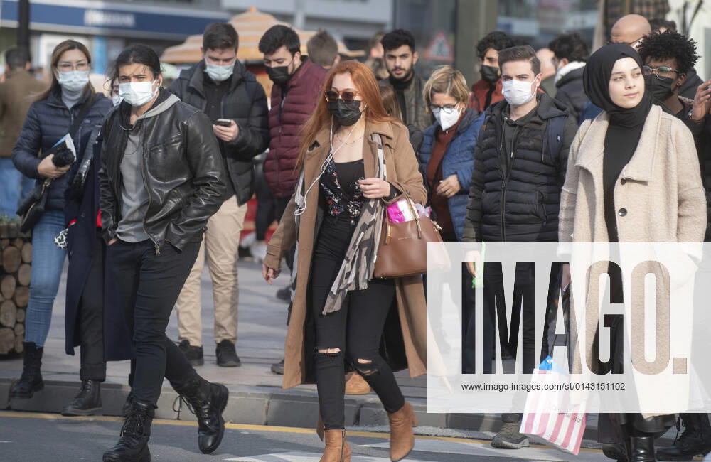 People wearing face masks walk on a street in Ankara, Turkey, on November 28, 2021. Turkey confirmed 21,655 new COVID-19 cases, raising its tally of infections to 8,746,055 according to its health ministry. Some 213 persons died of Covid-9 today, increasing the death toll from the virus in Turkey to 76,446. (