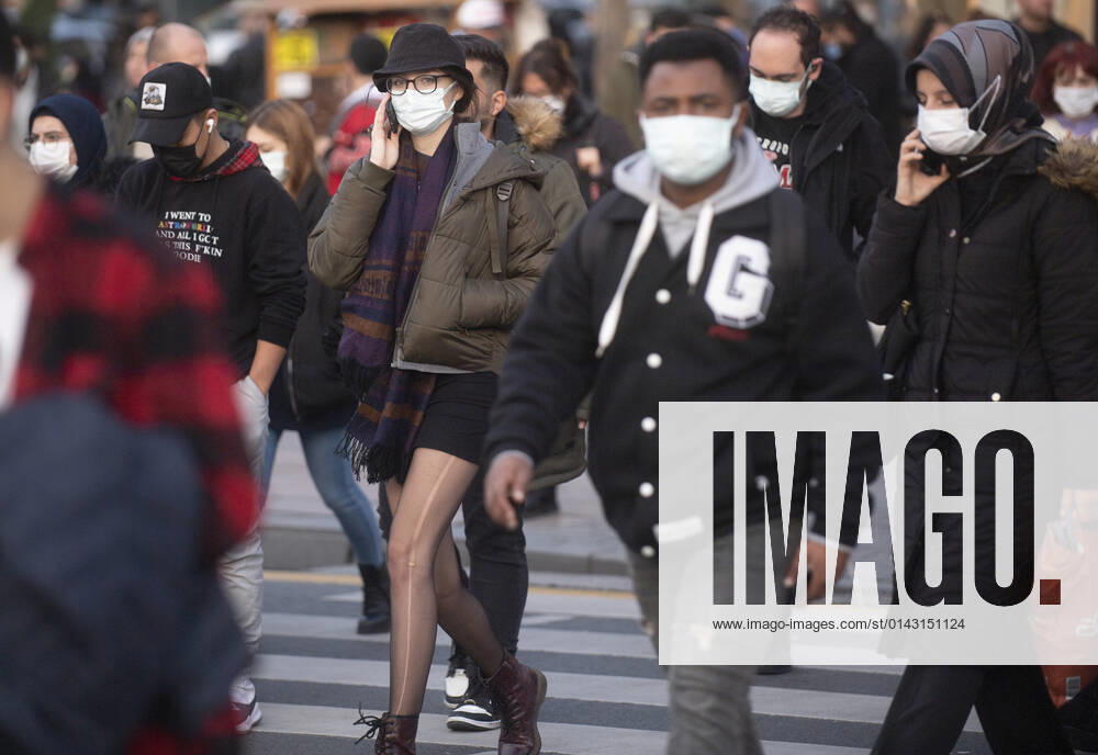 People wearing face masks walk on a street in Ankara, Turkey, on November 28, 2021. Turkey confirmed 21,655 new COVID-19 cases, raising its tally of infections to 8,746,055 according to its health ministry. Some 213 persons died of Covid-9 today, increasing the death toll from the virus in Turkey to 76,446. (