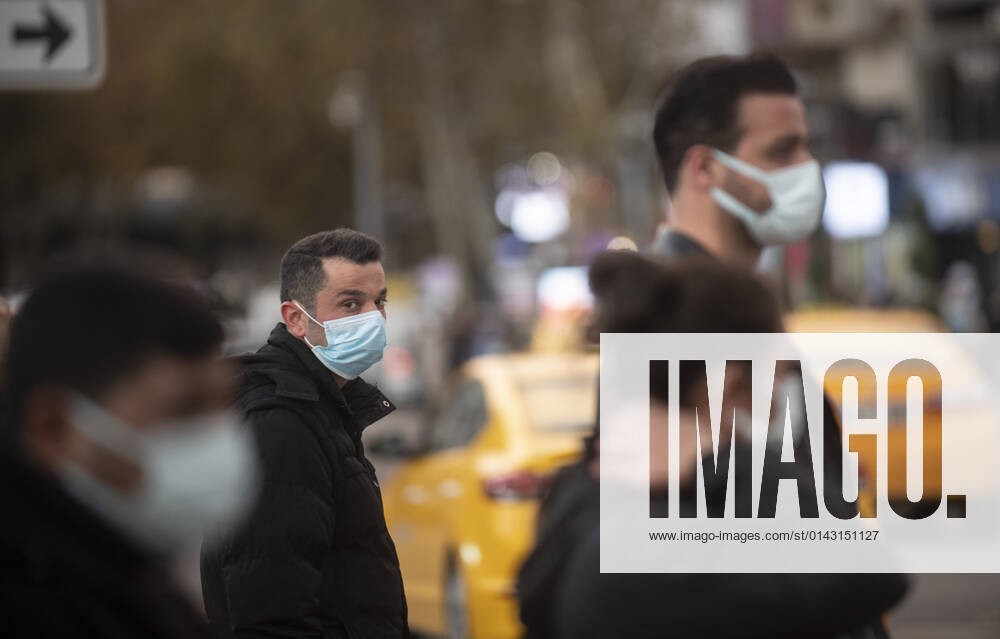 People wearing face masks walk on a street in Ankara, Turkey, on November 28, 2021. Turkey confirmed 21,655 new COVID-19 cases, raising its tally of infections to 8,746,055 according to its health ministry. Some 213 persons died of Covid-9 today, increasing the death toll from the virus in Turkey to 76,446. (
