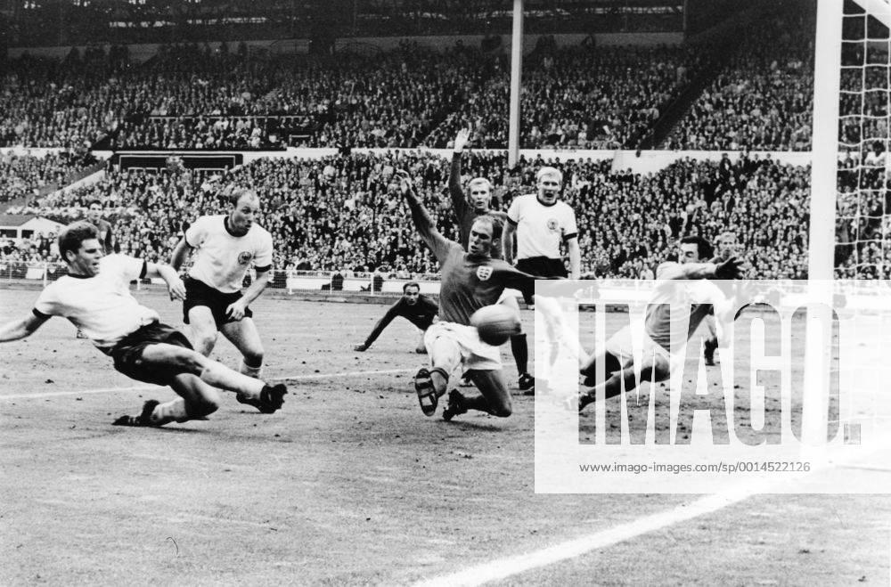 Just a few seconds to go in the World Cup Final and West Gemany s Wolfgang Weber side-foots the ball past England s Gordon Banks, Goalkeeper, to snatch the eualiserat Wembley Stadium July 30th 1966. In the extra time that followed, England scored twice to end up 4-2 winners. Also in this picture are West German captain Uwe Seeler (second left) England s Ramon Wilson (dark shirt); behind Wilson is Moore, the England captain; Schnellinger (white shirt) and in the background extreme right, Jackie Charlton. Just seen in hte background centre, is George Cohen, the other England pull back. 30th July 1966 UnitedArchives01028390