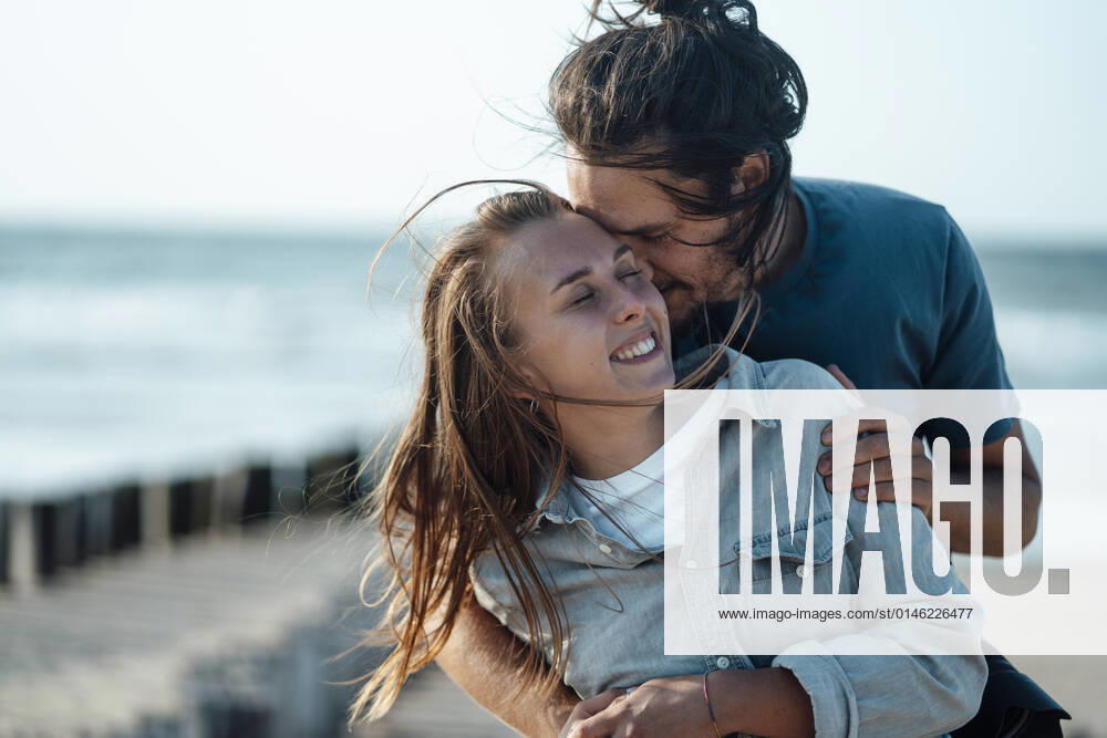 Affectionate couple embracing at beach model released, GUSF06621